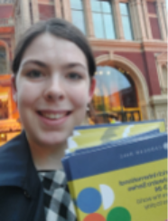 Mobius street team member holding Cadogan Hall brochures outside the Royal Albert Hall