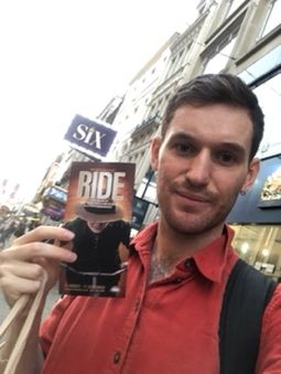 Mobius street team member holding a Ride flyer outside Six at the Vaudeville Theatre, London