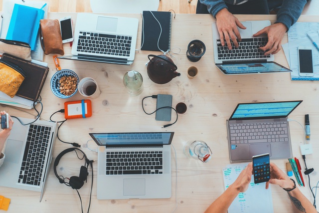 View birdseye view of people working together round a desk